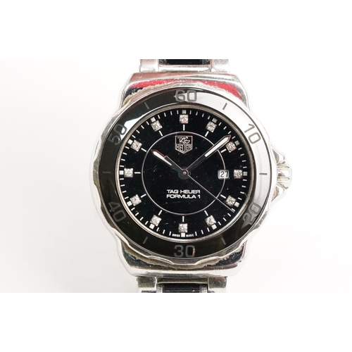 319 - Tag Heuer Formula 1 ladies wrist watch. The watch having a round face with black dial with diamond s... 