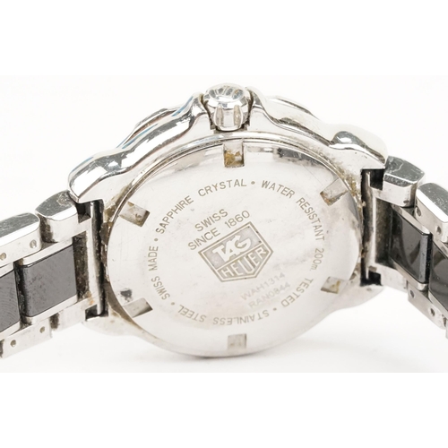 319 - Tag Heuer Formula 1 ladies wrist watch. The watch having a round face with black dial with diamond s... 