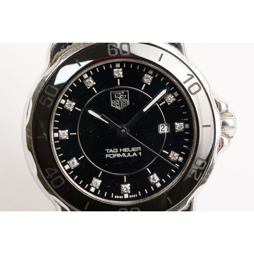 319 - Tag Heuer Formula 1 ladies wrist watch. The watch having a round face with black dial with diamond s... 