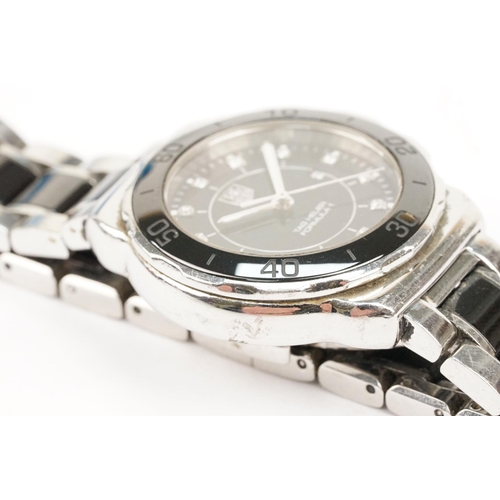 319 - Tag Heuer Formula 1 ladies wrist watch. The watch having a round face with black dial with diamond s... 