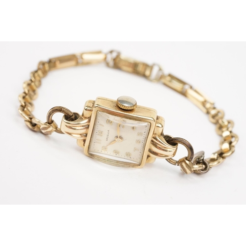 322 - 9ct gold Ravella wrist watch having a square face on a gold plated strap. Case measures approx 15mm ... 