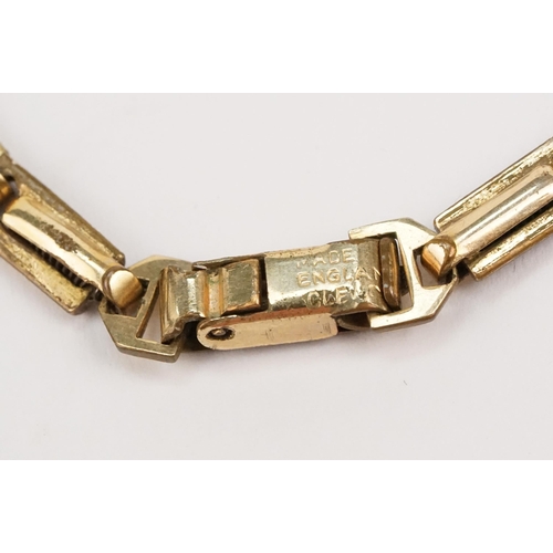 322 - 9ct gold Ravella wrist watch having a square face on a gold plated strap. Case measures approx 15mm ... 