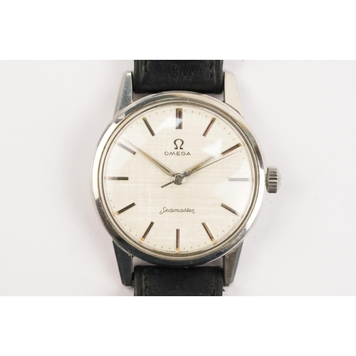 324 - 1960s Omega Seamaster wristwatch. The watch having a round face with silver baton markers to the cha... 