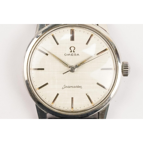 324 - 1960s Omega Seamaster wristwatch. The watch having a round face with silver baton markers to the cha... 