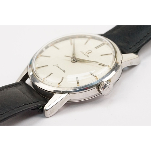 324 - 1960s Omega Seamaster wristwatch. The watch having a round face with silver baton markers to the cha... 