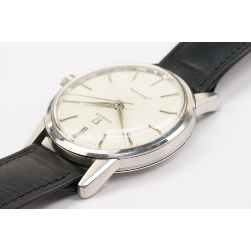 324 - 1960s Omega Seamaster wristwatch. The watch having a round face with silver baton markers to the cha... 