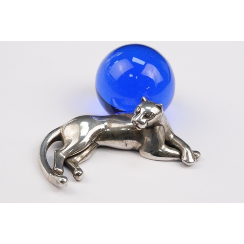 338 - Cartier silver panther paperweight in the form of a recumbent panther with blue glass orb. Signed Ca... 