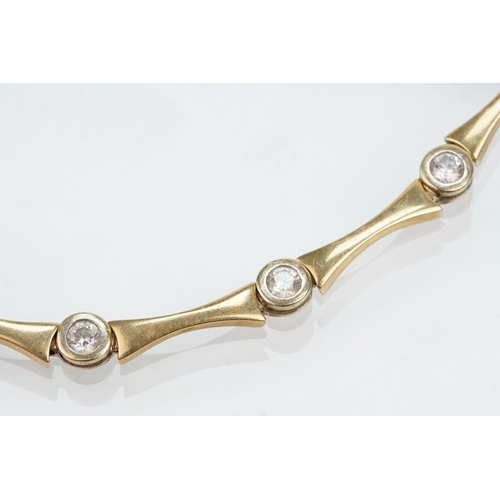 45 - 14ct gold and cz line bracelet being bezel set with round cut cz's with spacer links. Marked 585 to ... 