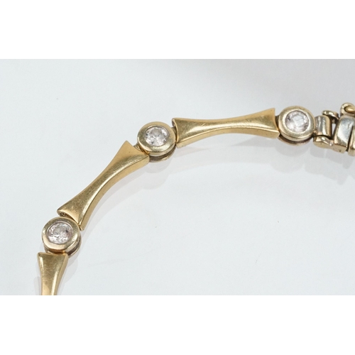 45 - 14ct gold and cz line bracelet being bezel set with round cut cz's with spacer links. Marked 585 to ... 