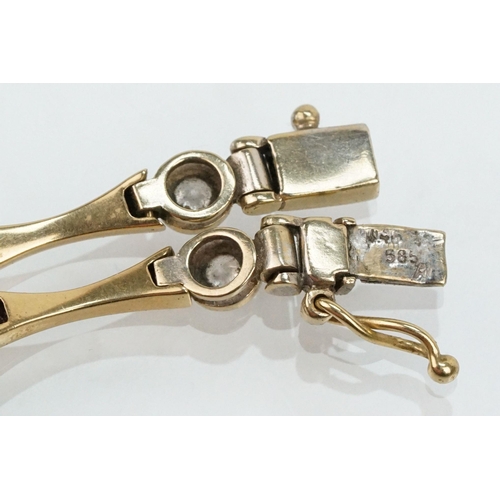 45 - 14ct gold and cz line bracelet being bezel set with round cut cz's with spacer links. Marked 585 to ... 