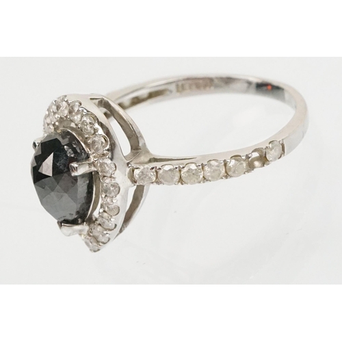 49 - 14ct white gold and black diamond ring. The ring being set with a pearl cut black diamond to centre ... 