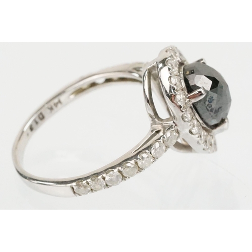 49 - 14ct white gold and black diamond ring. The ring being set with a pearl cut black diamond to centre ... 