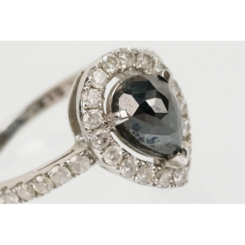 49 - 14ct white gold and black diamond ring. The ring being set with a pearl cut black diamond to centre ... 