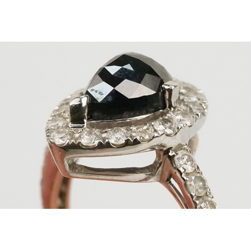 49 - 14ct white gold and black diamond ring. The ring being set with a pearl cut black diamond to centre ... 