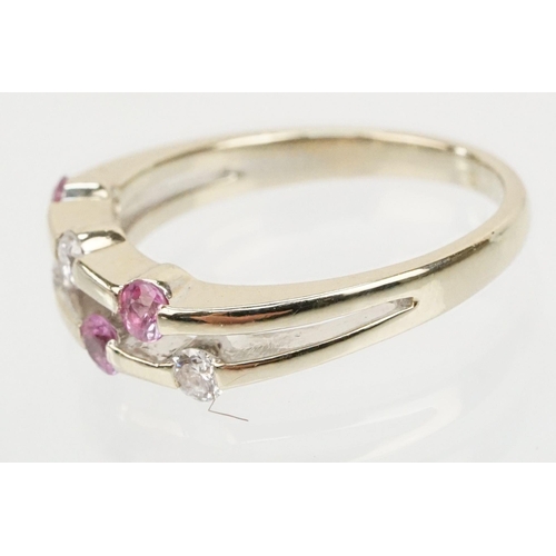 51 - 18ct white gold diamond and pink sapphire ring. The ring having a split band channel set with three ... 