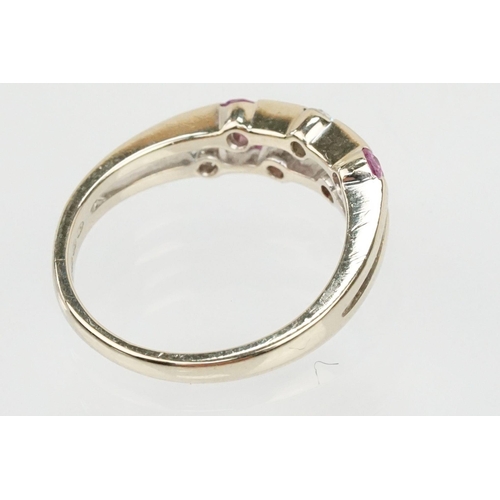 51 - 18ct white gold diamond and pink sapphire ring. The ring having a split band channel set with three ... 