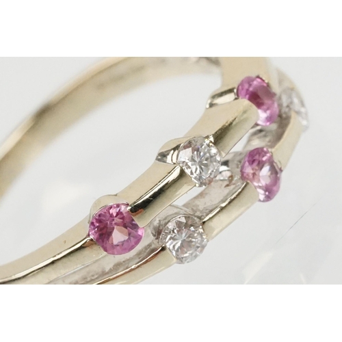 51 - 18ct white gold diamond and pink sapphire ring. The ring having a split band channel set with three ... 