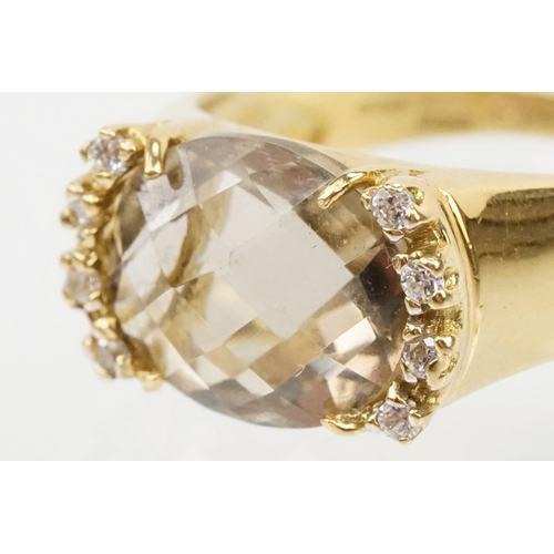 56 - 18ct gold, smoky quartz and diamond ring. The ring being set with an oval faceted smoky quartz flank... 