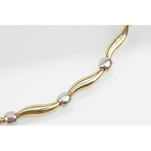 58 - 14ct gold two tone necklace chain with curved design links. Clasp marked 14k. Measures 17.5 inches.