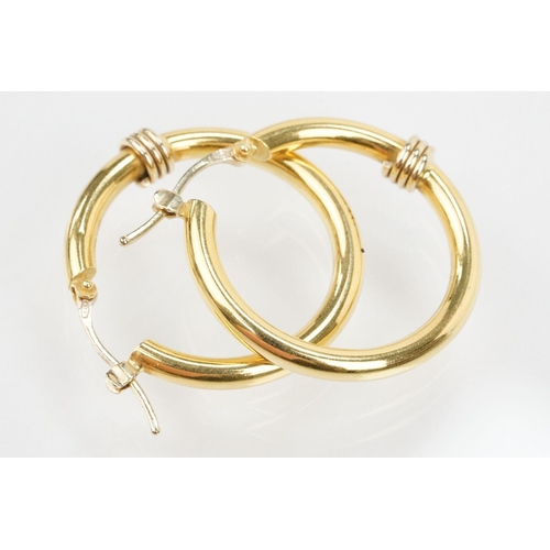 68 - Pair of 18ct gold hoop earrings having hinge posts with coiled detail to front. Italian hallmarked t... 