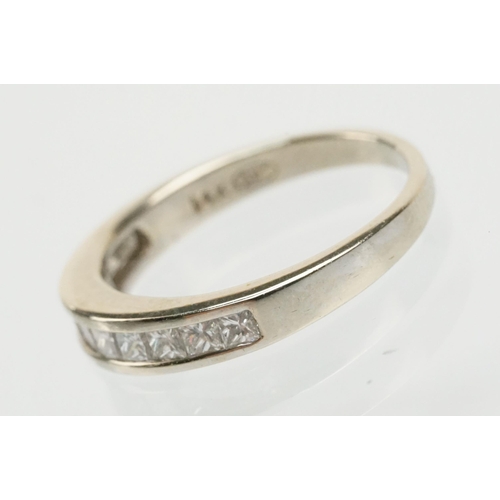 13 - 14ct white gold and diamond half eternity ring channel set with eleven princess cut diamonds. Marked... 