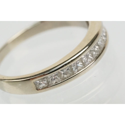 13 - 14ct white gold and diamond half eternity ring channel set with eleven princess cut diamonds. Marked... 