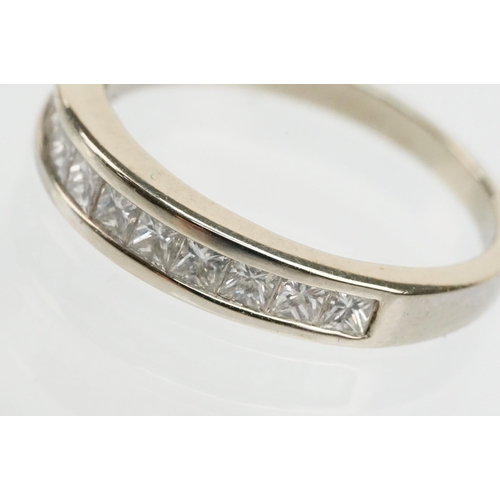 13 - 14ct white gold and diamond half eternity ring channel set with eleven princess cut diamonds. Marked... 