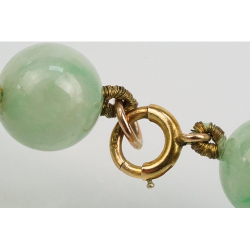 16 - Jade beaded necklace threaded with green jadeite spherical beads with a 9ct gold clasp. Measures 15 ... 