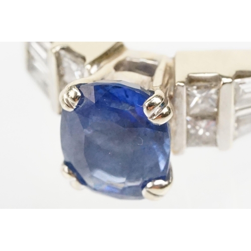 2 - 18ct white gold, sapphire and diamond ring. The ring being set with an oval mixed cut blue sapphire ... 