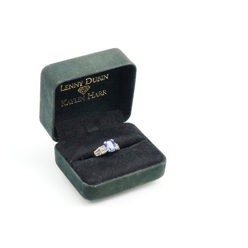 2 - 18ct white gold, sapphire and diamond ring. The ring being set with an oval mixed cut blue sapphire ... 