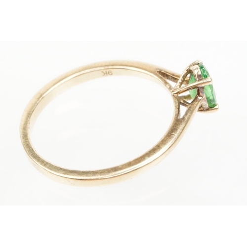 247 - 9ct gold Tsavorite garnet ring. The ring being set with an oval cut tsavorite garnet in a four prong... 