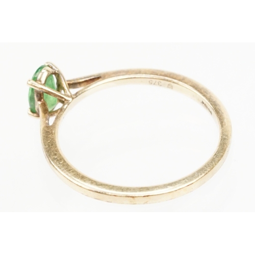 247 - 9ct gold Tsavorite garnet ring. The ring being set with an oval cut tsavorite garnet in a four prong... 