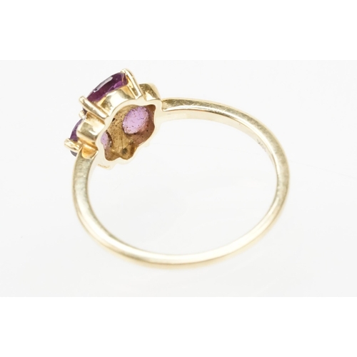 249 - 9ct gold Comeria garnet and diamond cluster ring. The ring being set with three oval cut purple garn... 