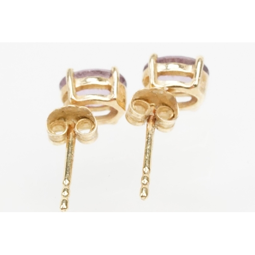 250 - Four pairs of 9ct gold earrings to include a pair of tanzanite drop earrings, a pair of tanzanite st... 