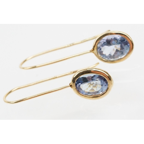 250 - Four pairs of 9ct gold earrings to include a pair of tanzanite drop earrings, a pair of tanzanite st... 