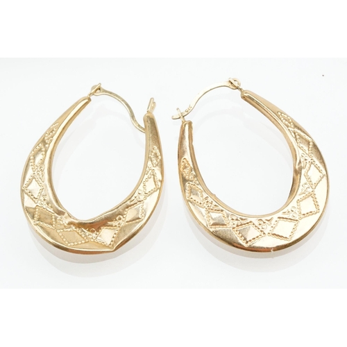 265 - Four pairs of 9ct gold hoop earrings including two tone examples. All marked 375. Largest measures 2... 