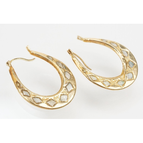 265 - Four pairs of 9ct gold hoop earrings including two tone examples. All marked 375. Largest measures 2... 