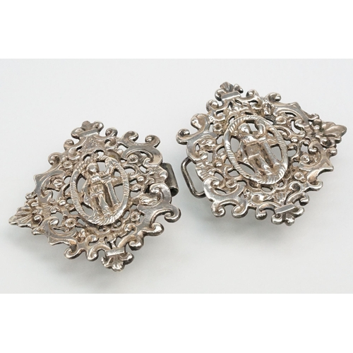 271 - Two silver nurses belt buckles to include an example featuring classical cherubs with grape vines an... 