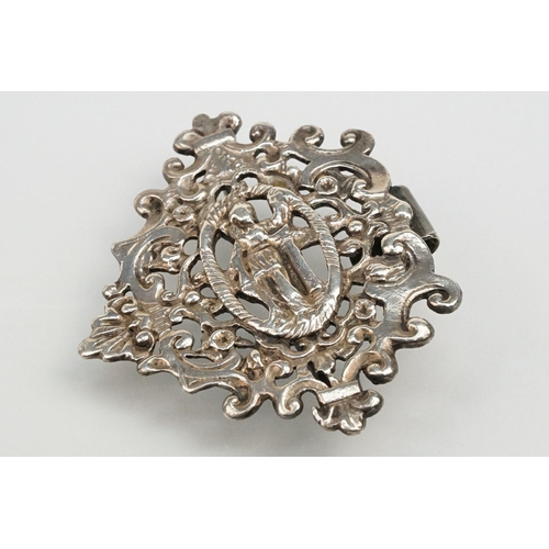 271 - Two silver nurses belt buckles to include an example featuring classical cherubs with grape vines an... 