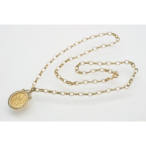 272 - 1913 half sovereign coin pendant set within a 9ct gold mount on a 9ct spectacle chain. Mount hallmar... 