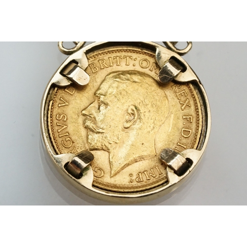 272 - 1913 half sovereign coin pendant set within a 9ct gold mount on a 9ct spectacle chain. Mount hallmar... 