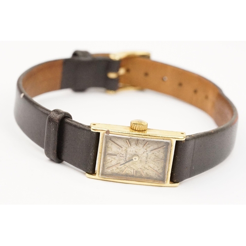 279 - Omega De Ville 18ct gold case ladies wrist watch having a rectangular face with baton markers to the... 