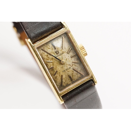 279 - Omega De Ville 18ct gold case ladies wrist watch having a rectangular face with baton markers to the... 