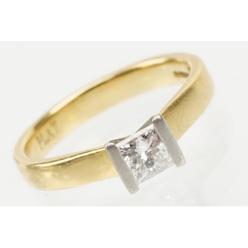 33 - 18ct gold and diamond solitaire ring. The ring being channel set with a princess cut diamond to the ... 