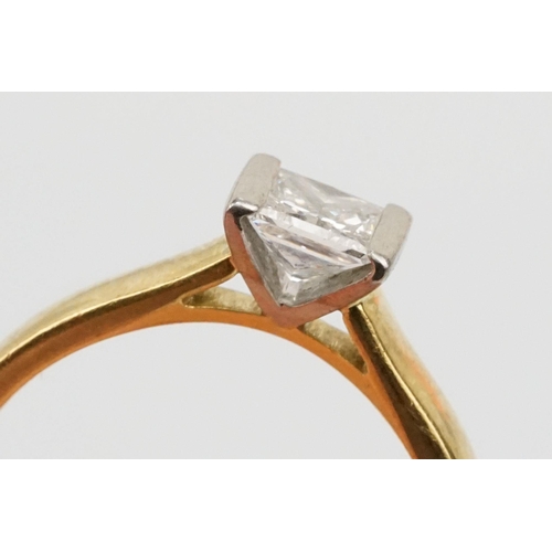 33 - 18ct gold and diamond solitaire ring. The ring being channel set with a princess cut diamond to the ... 