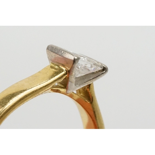 33 - 18ct gold and diamond solitaire ring. The ring being channel set with a princess cut diamond to the ... 