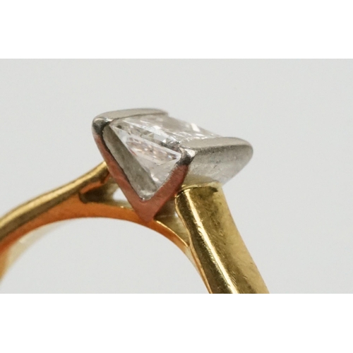 33 - 18ct gold and diamond solitaire ring. The ring being channel set with a princess cut diamond to the ... 