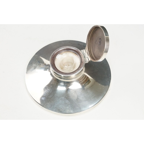 378 - 1920s silver hallmarked desk top ink well having a round concave base with hinged lid and glass line... 