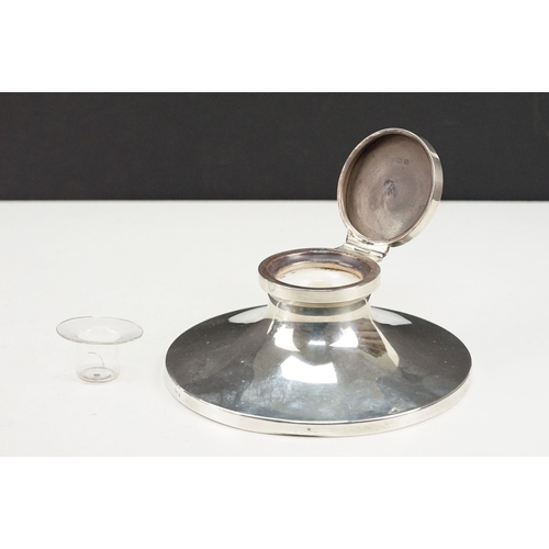 378 - 1920s silver hallmarked desk top ink well having a round concave base with hinged lid and glass line... 