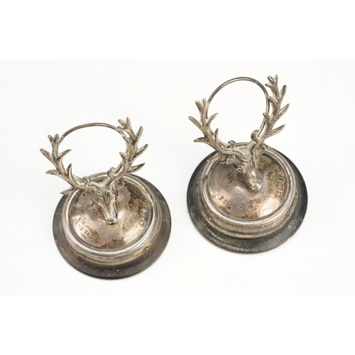 384 - Pair of early 20th Century Edwardian menu holders in the form of stags with red stone eyes, raised o... 